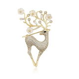 Enchanted Deer gold-tone brooch with white flowers and sparkling details